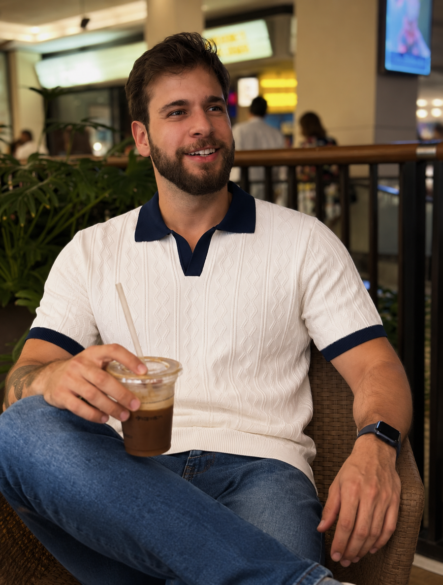 Customer wearing the navy knit polo by the coast